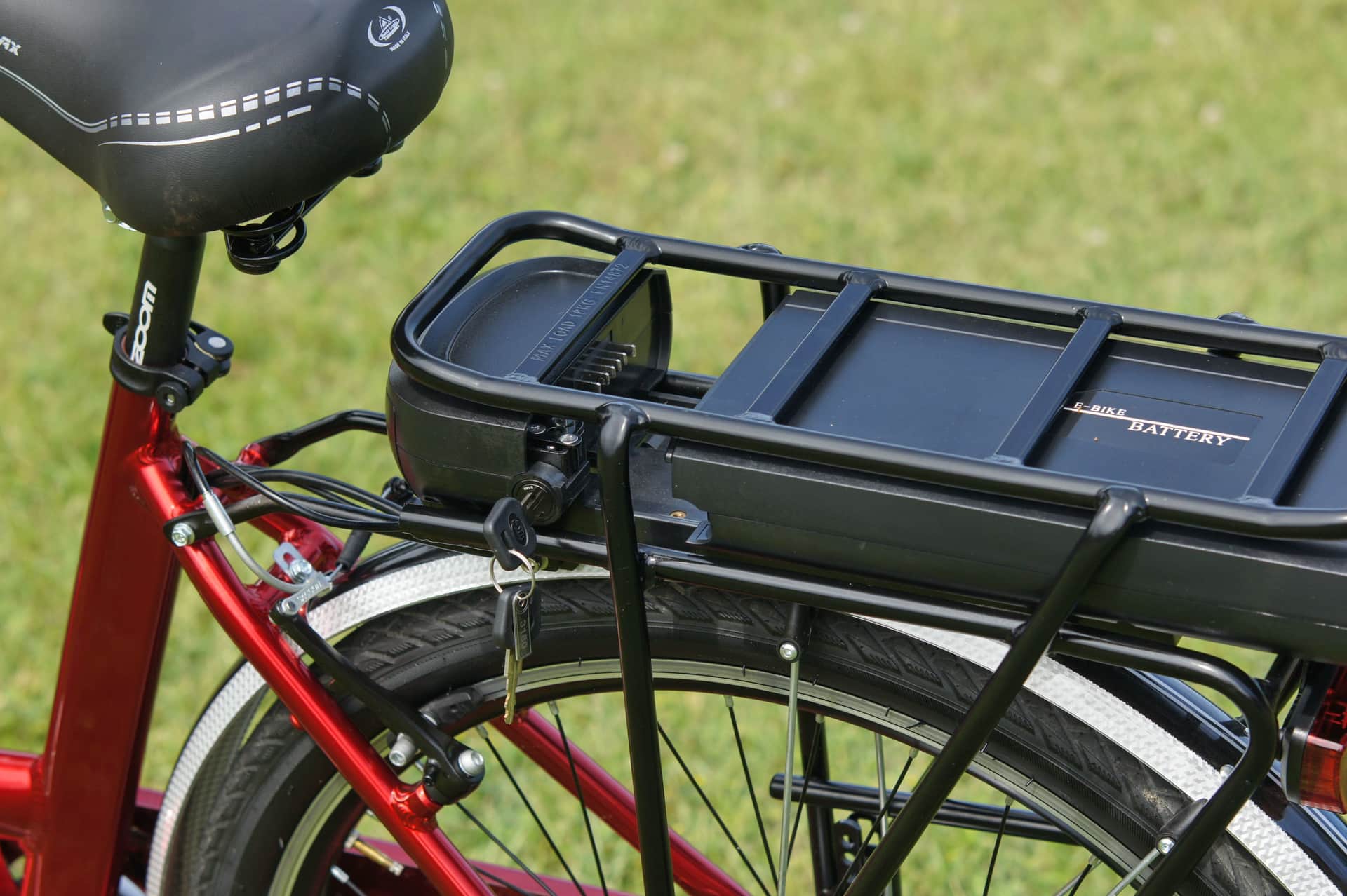 An electric bike battery charger plugged into a wall socket.